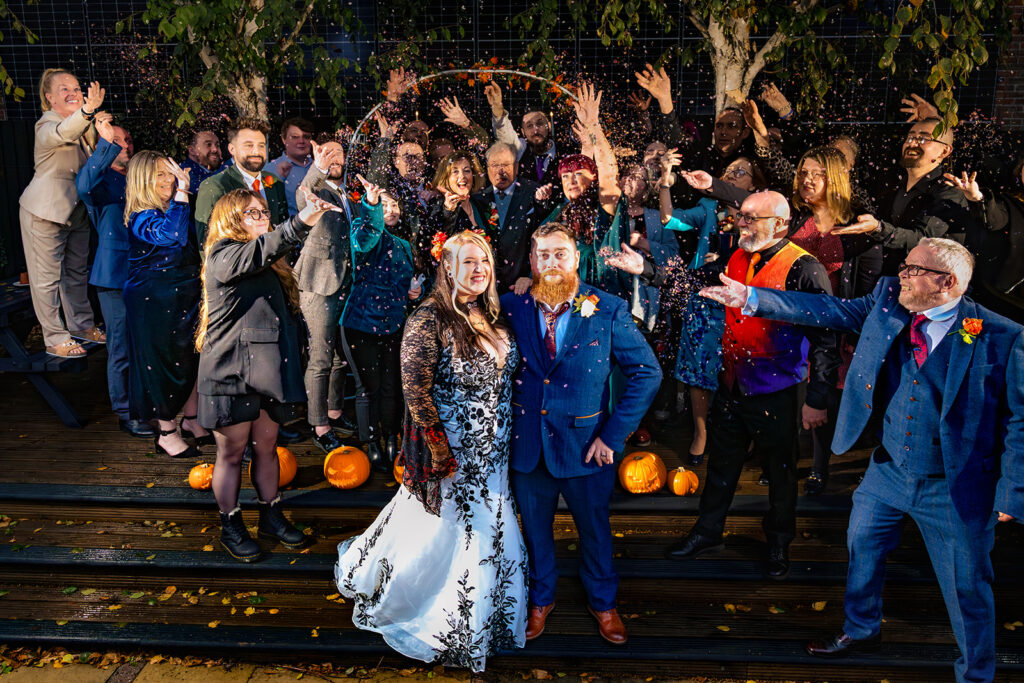 Group photo with flash at night at Halloween micro wedding, Southampton