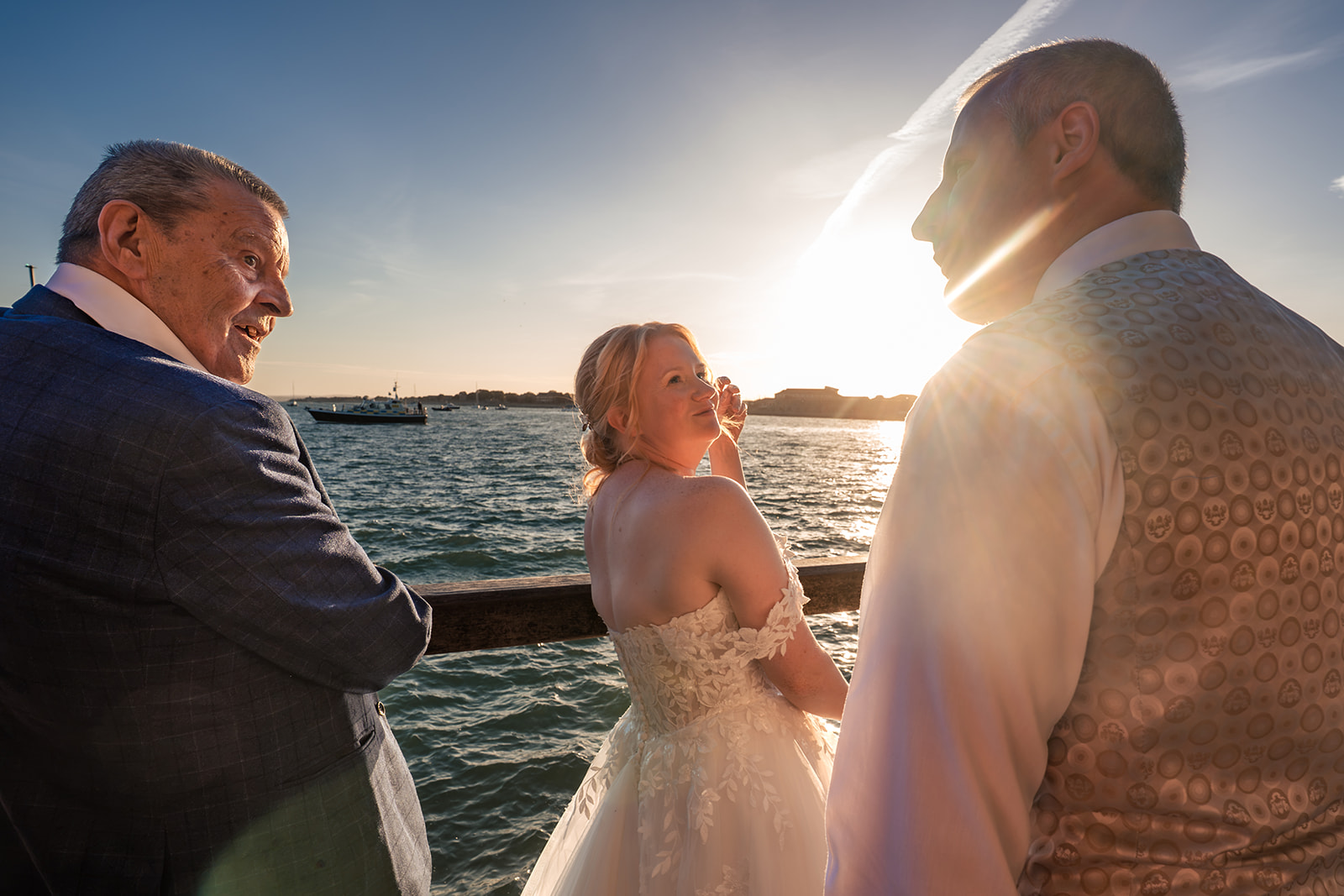 Bride and groom watching HMS Queen Elizabeth sail out of Portsmouth Harbour