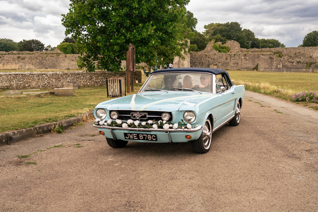 Vintage blue wedding car arriving at St Mary’s Church, Portchester