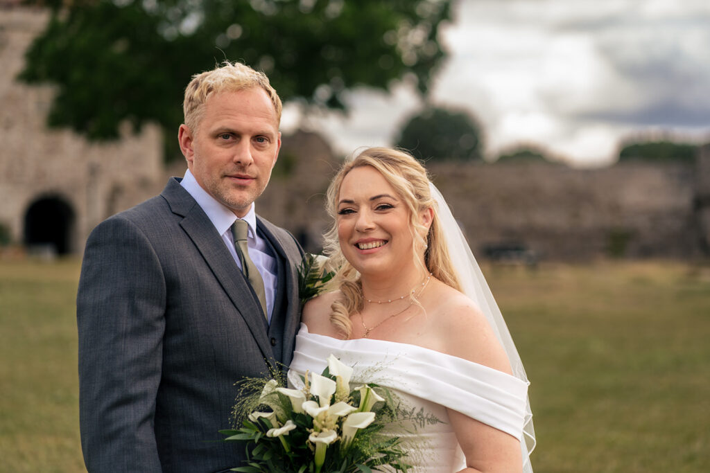 Bride and groom portrait in the churchyard at St Mary’s Church, Portchester