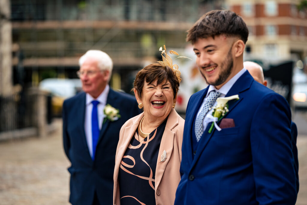 Groom laughing with family before the ceremony at Winchester Register Office