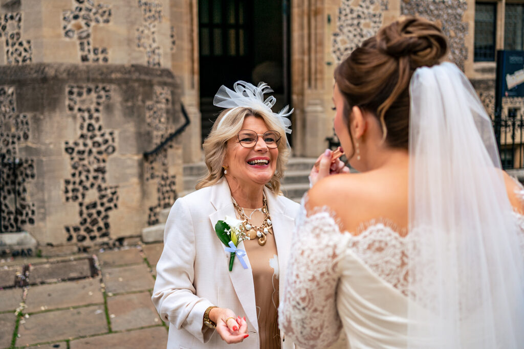 Bride greeting a guest outside at Winchester Register Office