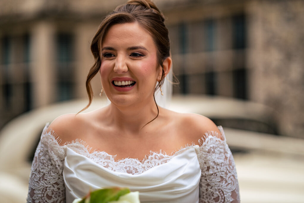 Bride beaming in the Winchester street at Winchester Register Office