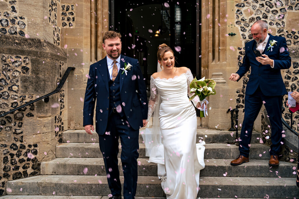 Newlyweds walking down the steps at Winchester Register Office