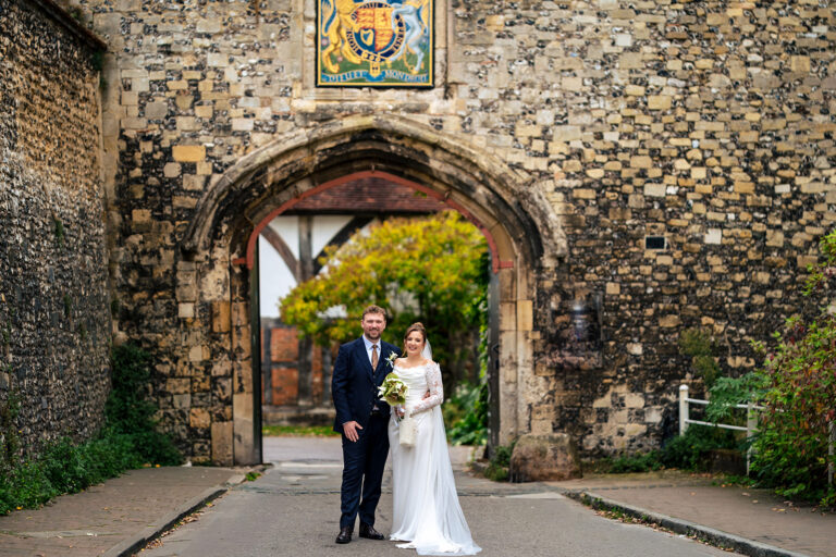 Couple walking through the stone archway at Winchester Register Office