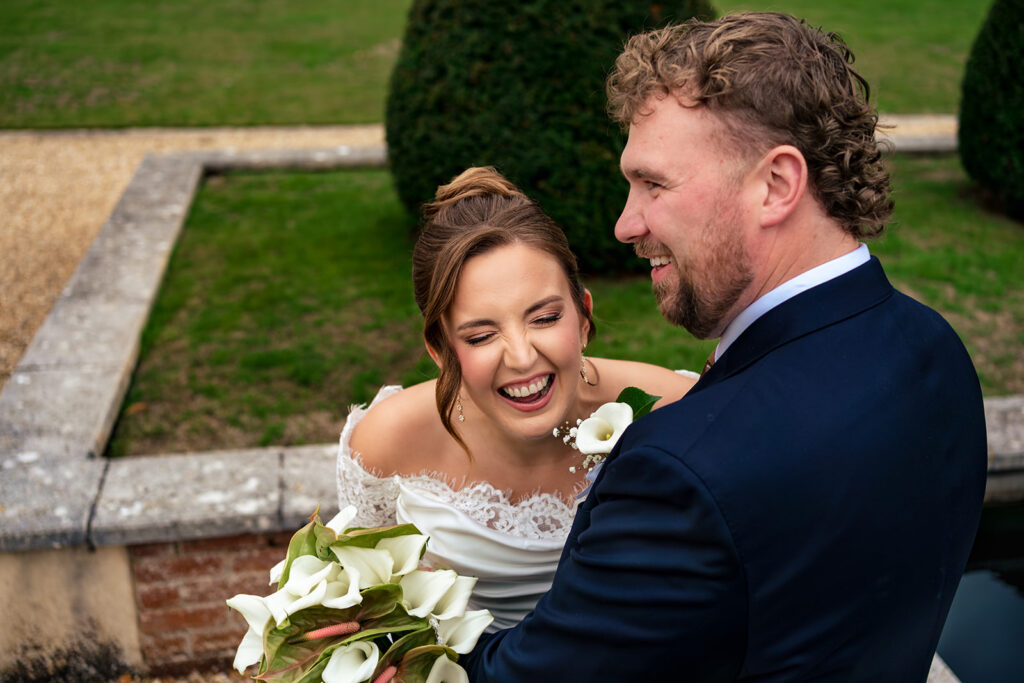 Groom twirling the bride in the gardens at Winchester Register Office