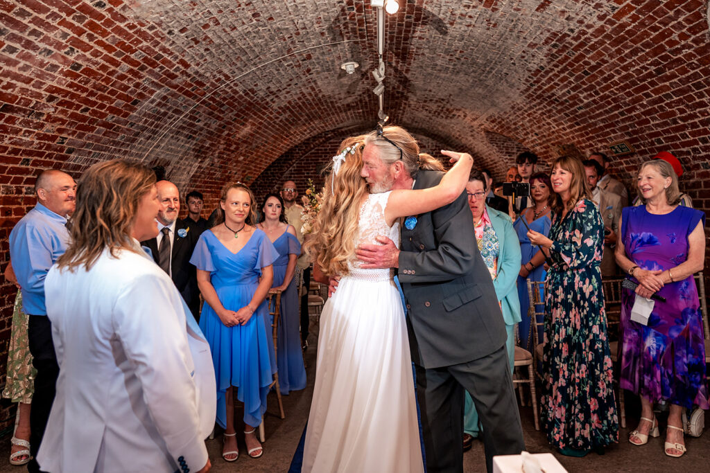 Two brides at the front of the ceremony at Southsea Castle