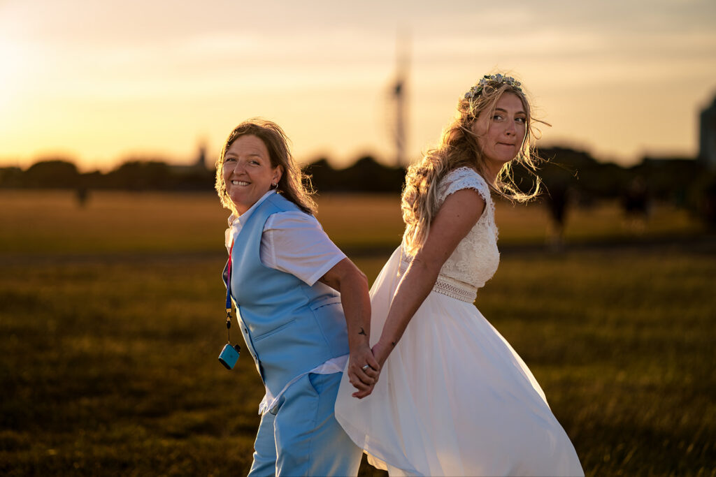 Two brides dancing at sunset