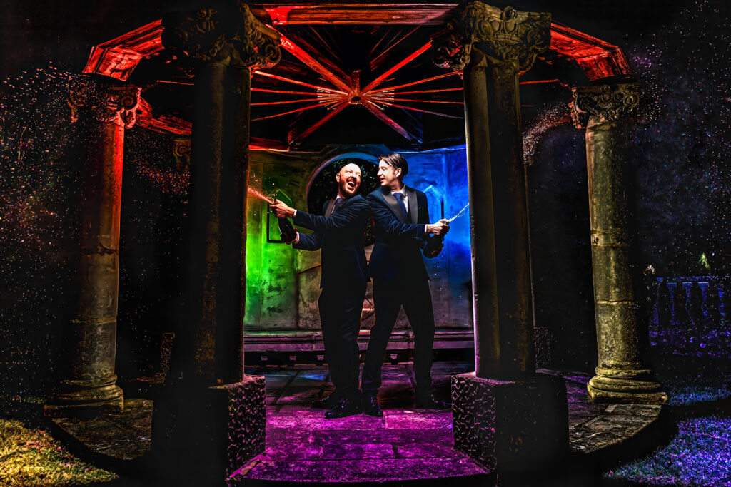 Couple lit with colourful off-camera flash under a gazebo at night