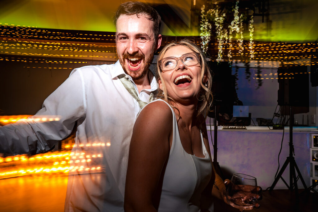 Groom and guest laughing on the dancefloor at Newtown House Hotel, Hayling Island