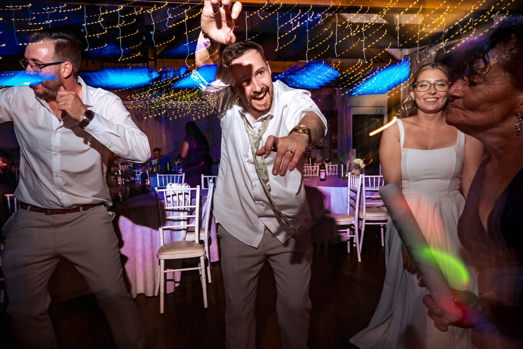 Groom dancing under the lights at Newtown House Hotel, Hayling Island