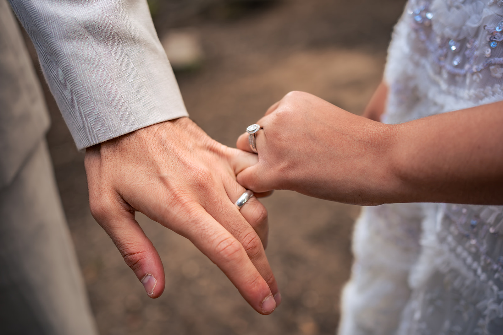 Couple holding hands detail during their post wedding shoot in Hampshire