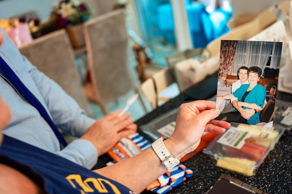 Groom looking at a family photo at Skylark Golf and Country Club, Whiteley