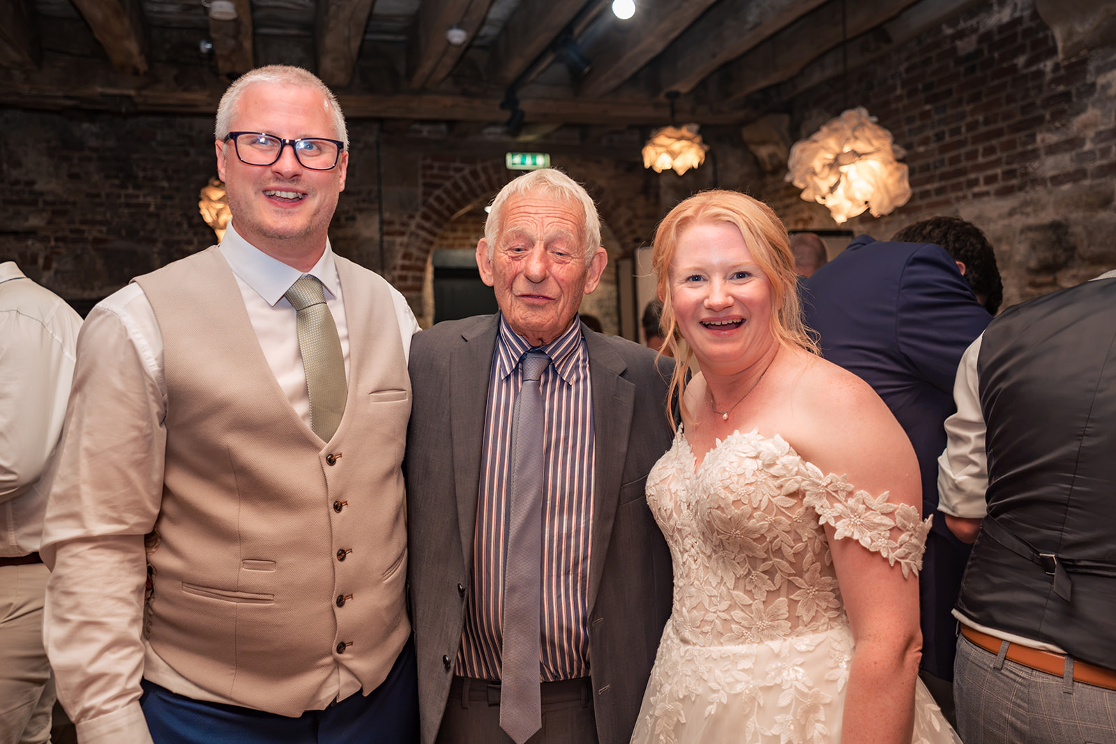 Bride and groom with an older guest at their Square Tower wedding