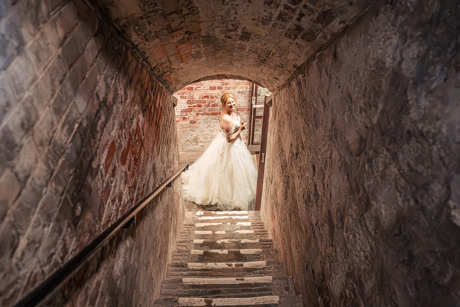 Bride at the end of the old stone tunnel at The Square Tower Old Portsmouth