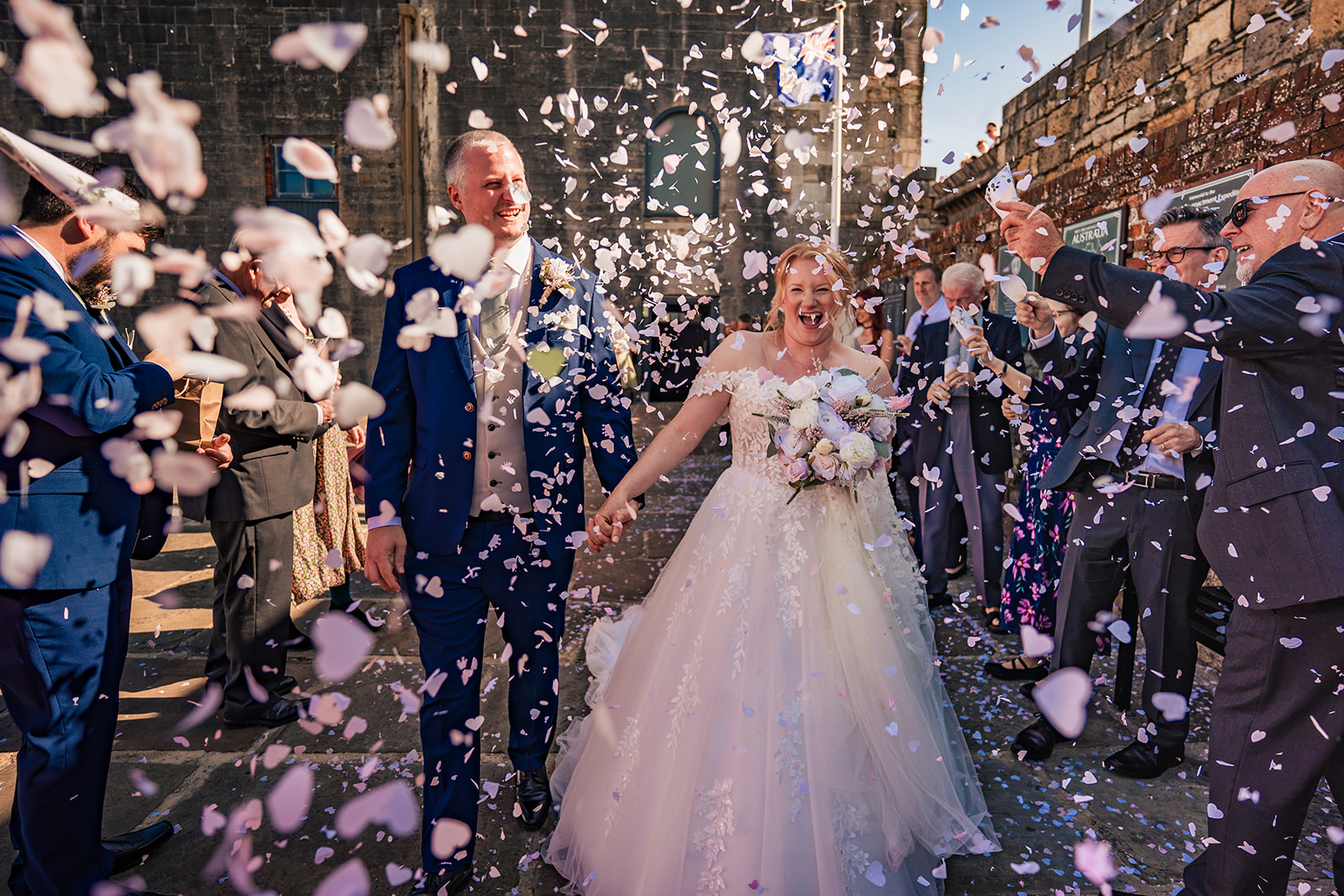 Bride and groom showered with confetti outside The Square Tower Old Portsmouth