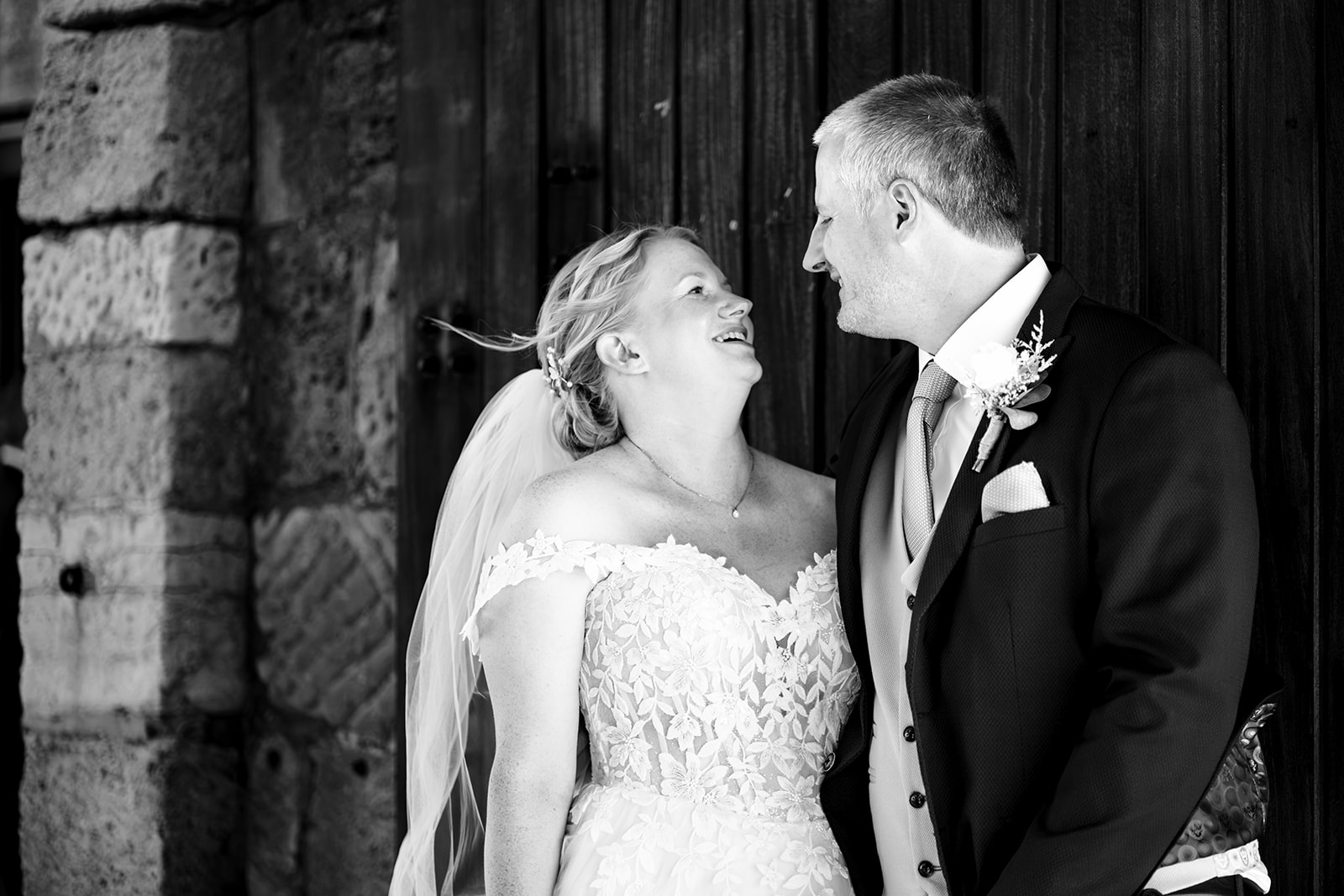 Bride and groom laughing together at The Square Tower, black and white