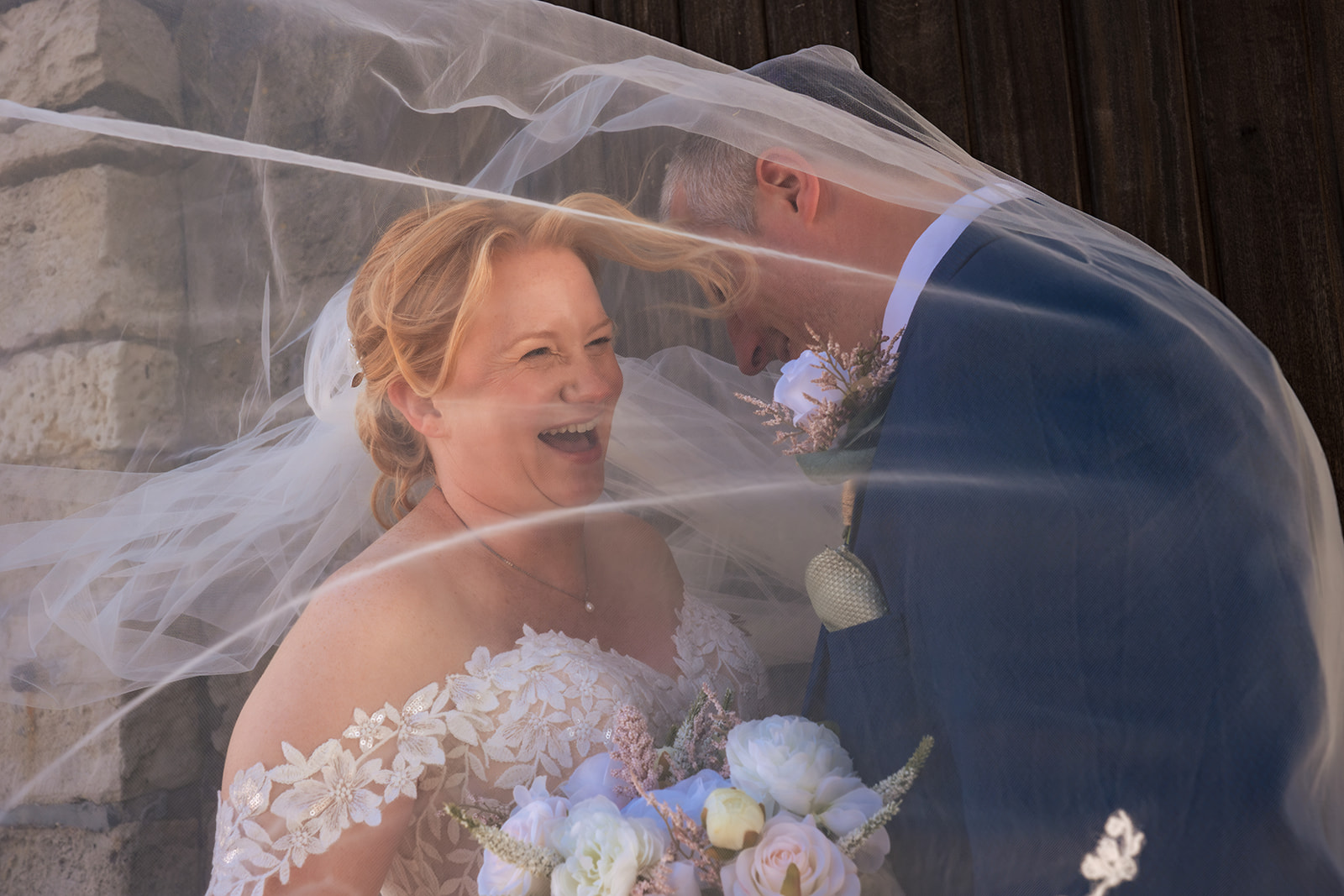 Bride and groom laughing under the veil at The Square Tower Old Portsmouth