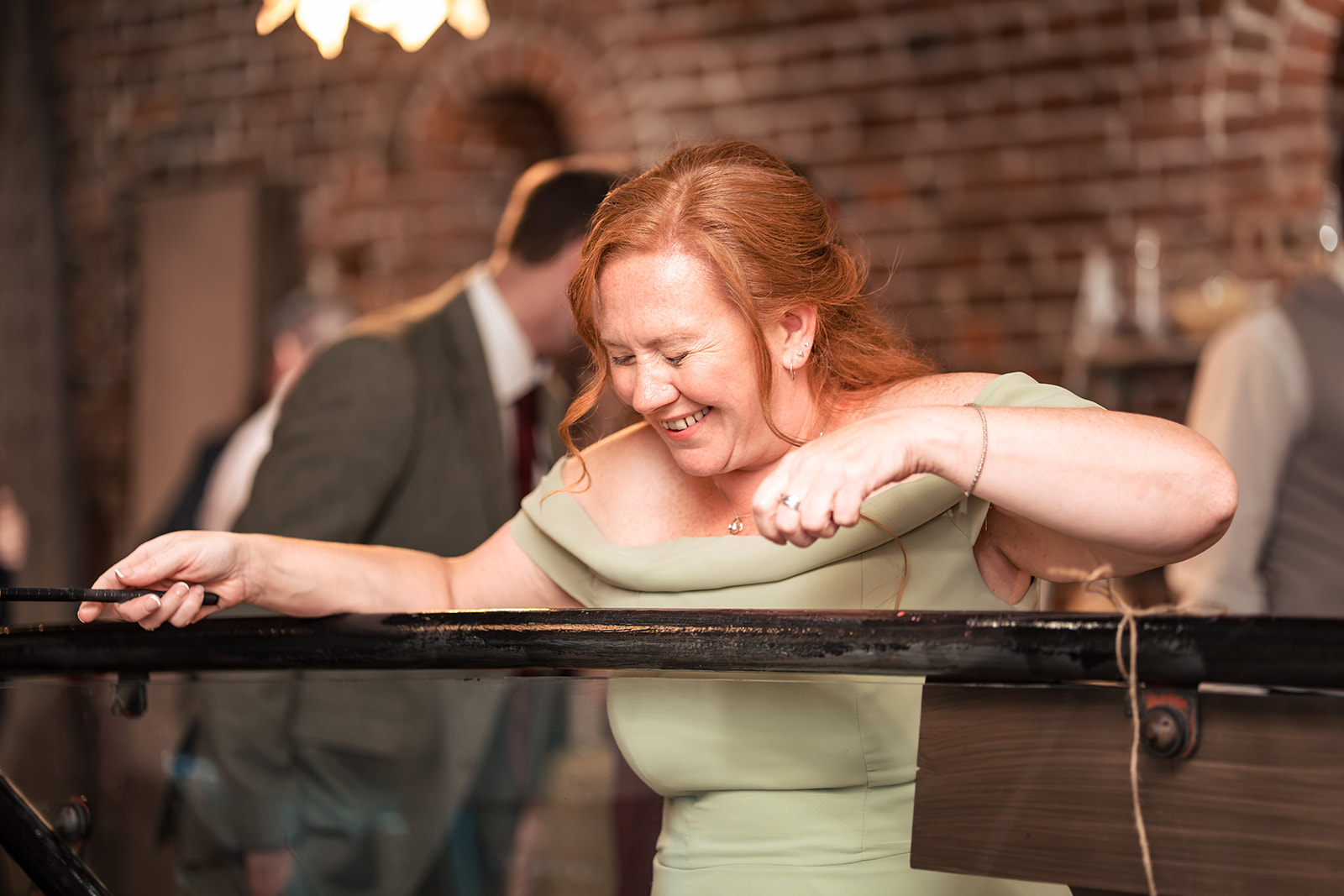 Guest in fits of laughter playing hook a duck at The Square Tower wedding