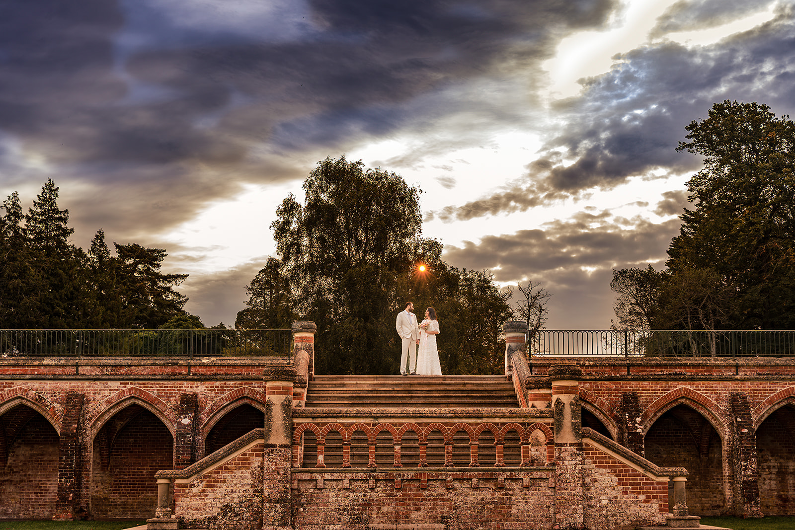 Couple on the old stone terrace at Staunton Country Park, lit with off camera flash on an early morning post wedding shoot