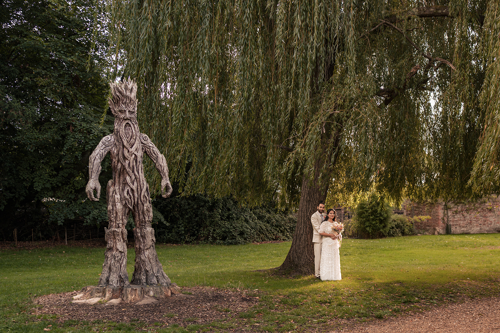Couple standing beside the giant wicker sculpture at Staunton Country Park