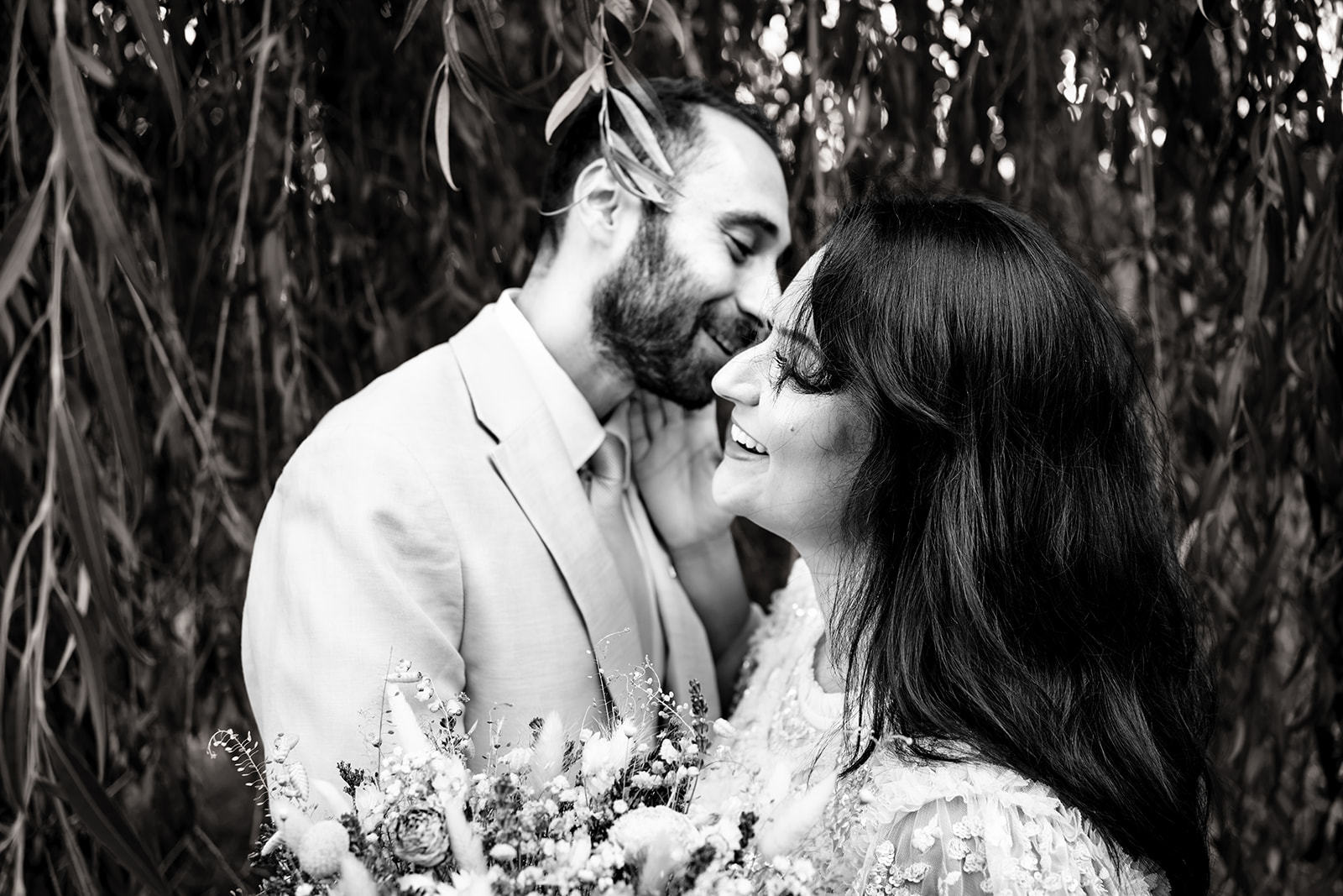 Couple nose to nose under the willow trees at Staunton Country Park, black and white