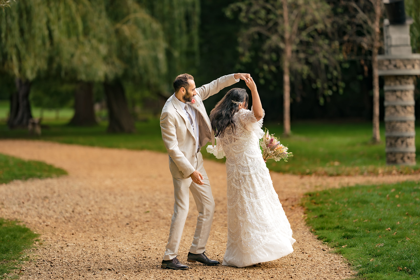 Groom twirling the bride on the path at Staunton Country Park