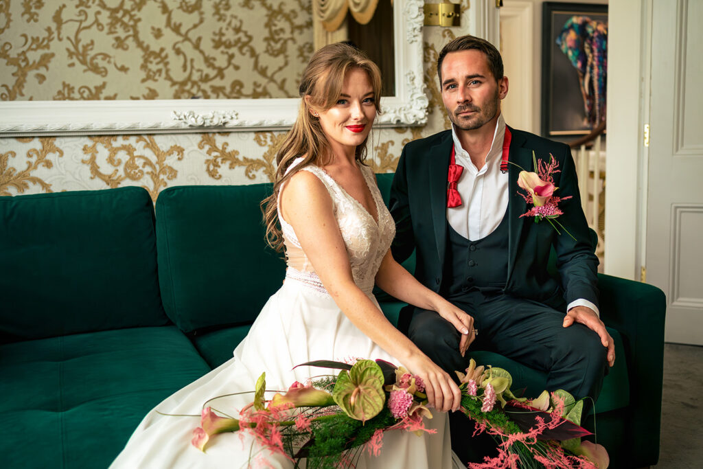 Couple on the green velvet sofa at Ashbys and Southsea Castle, styled shoot