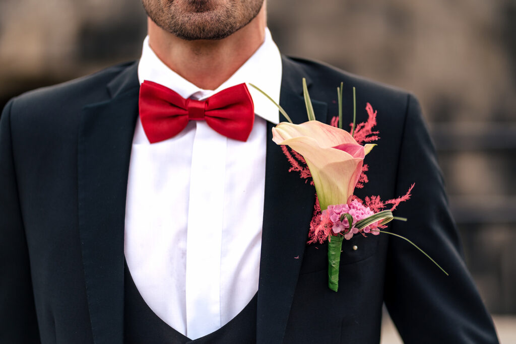 Red bow tie and buttonhole detail at Ashbys and Southsea Castle, styled shoot