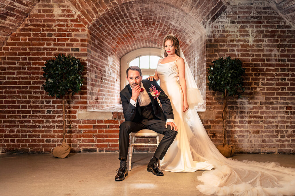 Couple in a brick archway at Ashbys and Southsea Castle, styled shoot