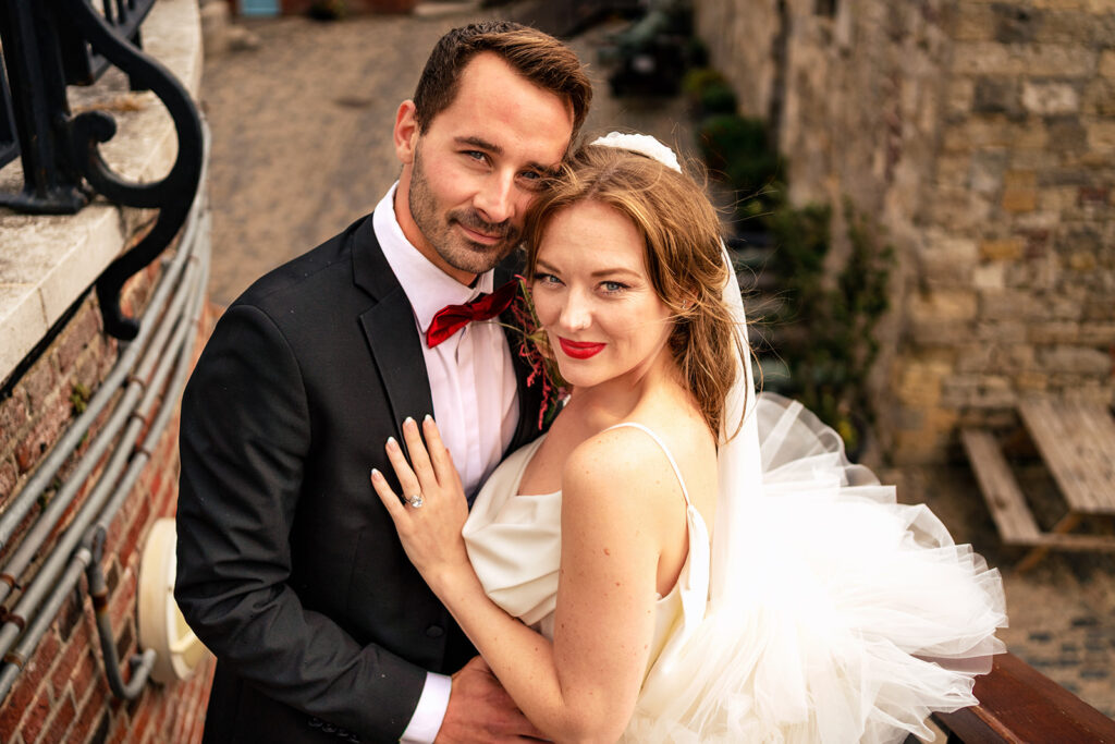 Couple embracing by the castle at Ashbys and Southsea Castle, styled shoot