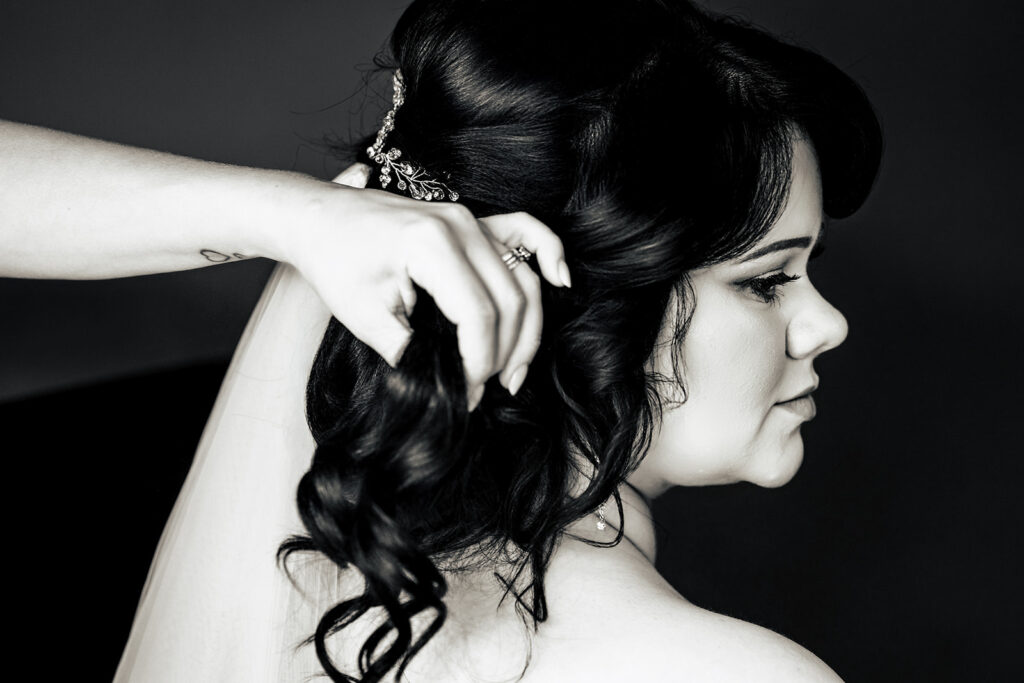 Bride’s hair being finished, black and white at Langstone Quays Resort, Hayling Island