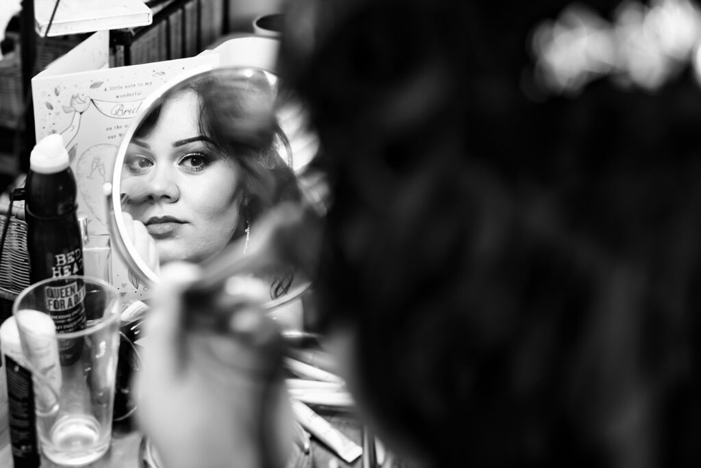 Bride getting ready reflected in the mirror, black and white at Langstone Quays Resort, Hayling Island