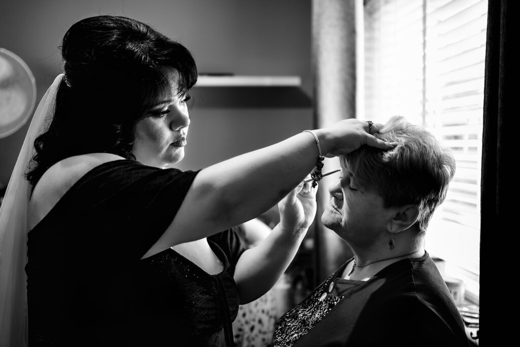 Final touches to the bride’s make up, black and white at Langstone Quays Resort, Hayling Island