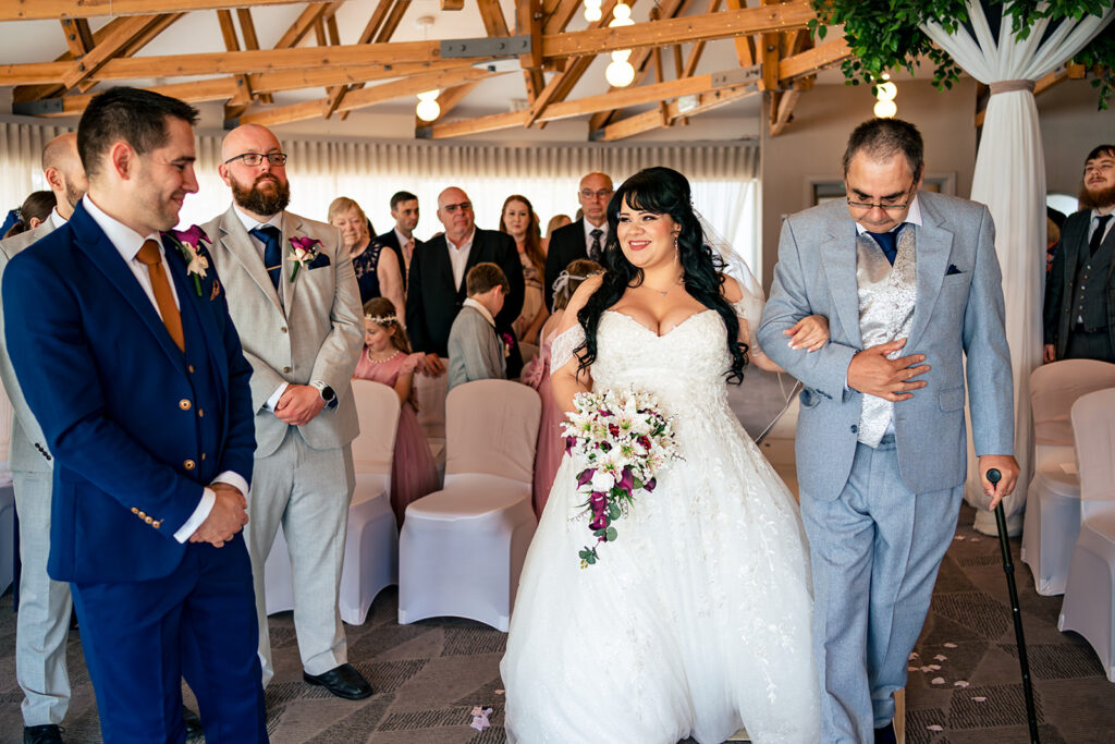 Bride walking down the aisle at Langstone Quays Resort, Hayling Island