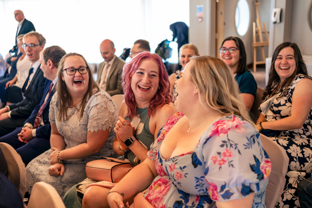 Guests laughing during the ceremony at Langstone Quays Resort, Hayling Island