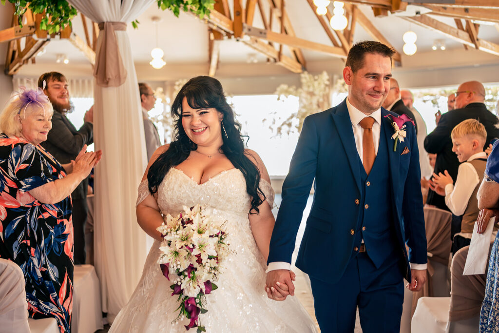 Just married walk back down the aisle at Langstone Quays Resort, Hayling Island