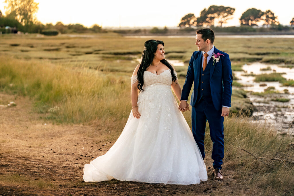 Couple walking across the saltmarsh at Langstone Quays Resort, Hayling Island