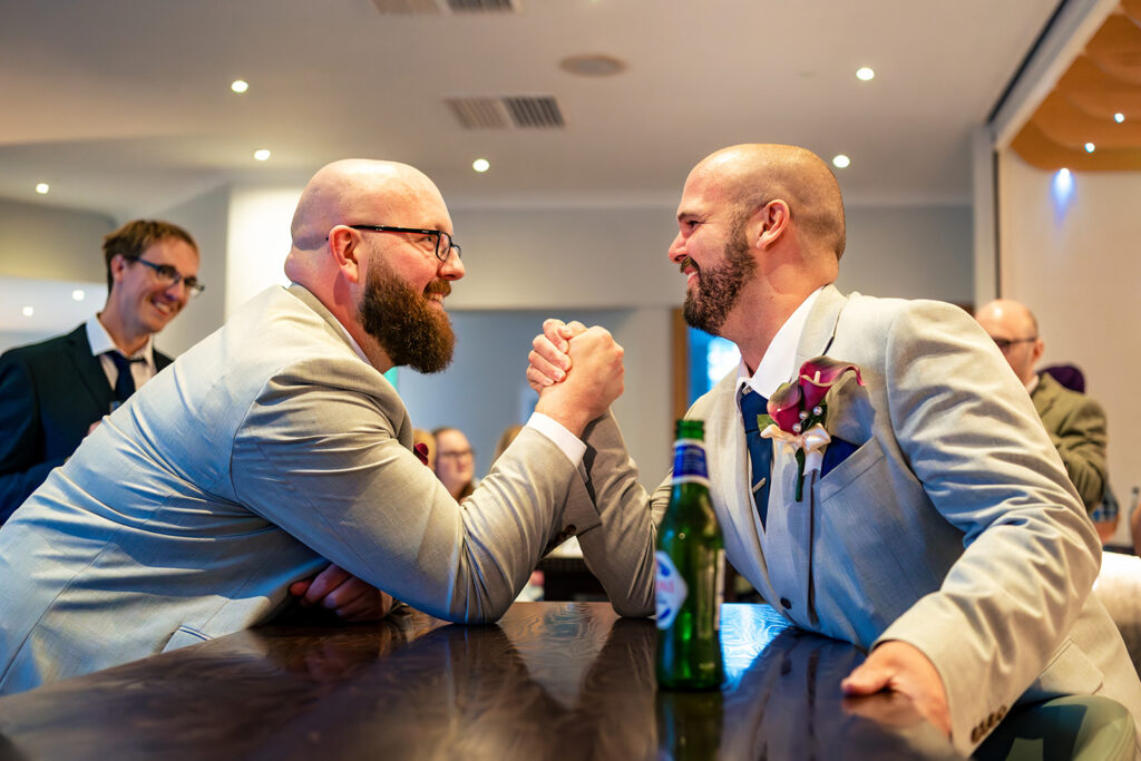 Arm wrestle between the groom and a guest at Langstone Quays Resort, Hayling Island