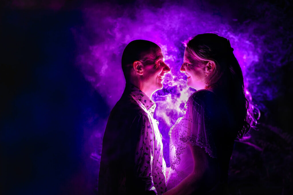 Creative purple flash silhouette portrait of the couple at Lodge Hill Centre, West Sussex