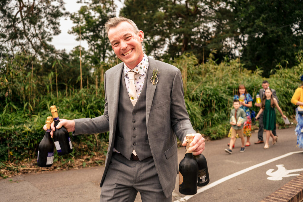 Groom laughing on the way to the ceremony at Lodge Hill Centre, West Sussex