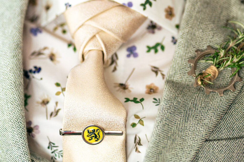 Close up of the groom’s floral tie and buttonhole at Lodge Hill Centre, West Sussex