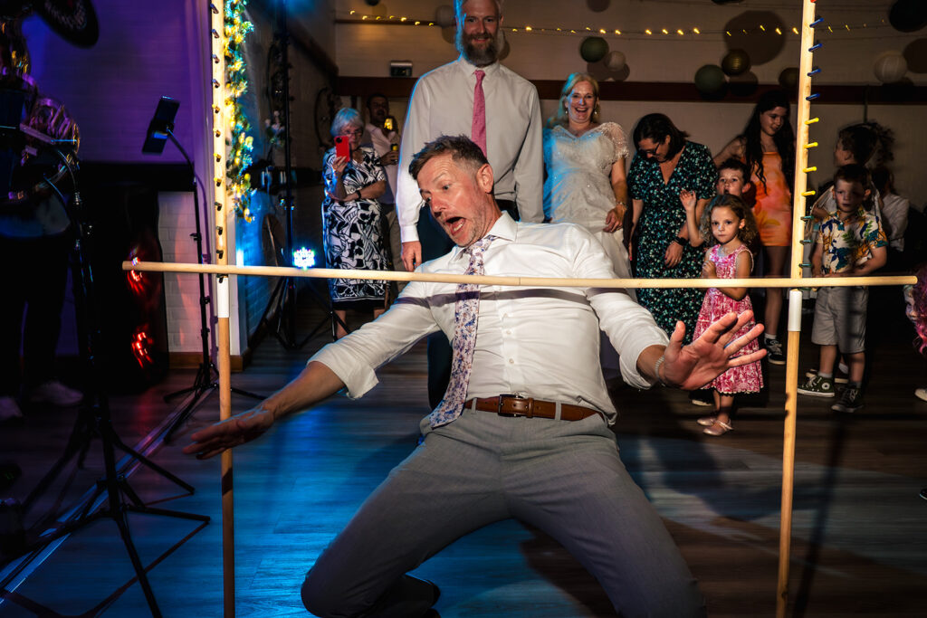 Guest doing the limbo on the dancefloor at Lodge Hill Centre, West Sussex