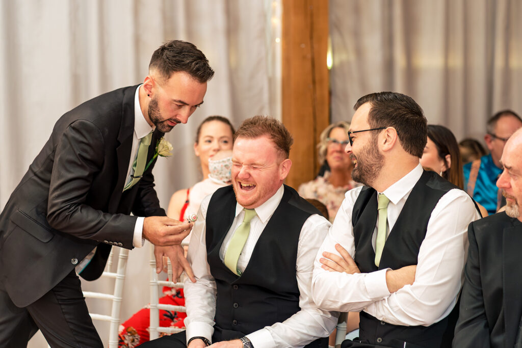 Groomsmen cracking up before the ceremony at Newtown House Hotel, Hayling Island