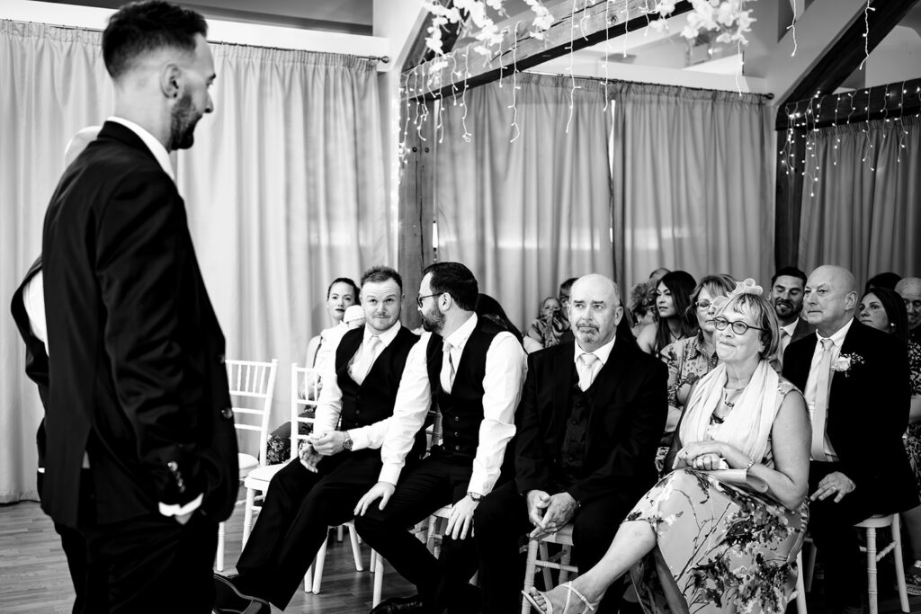 Guests waiting for the ceremony, black and white at Newtown House Hotel, Hayling Island
