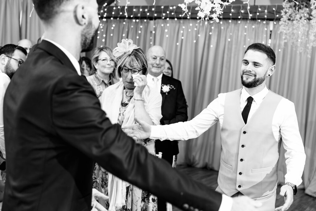 Groom laughing with the registrar, black and white at Newtown House Hotel, Hayling Island