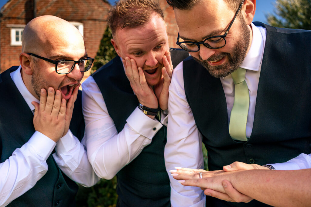 Groom laughing with his best man at Newtown House Hotel, Hayling Island