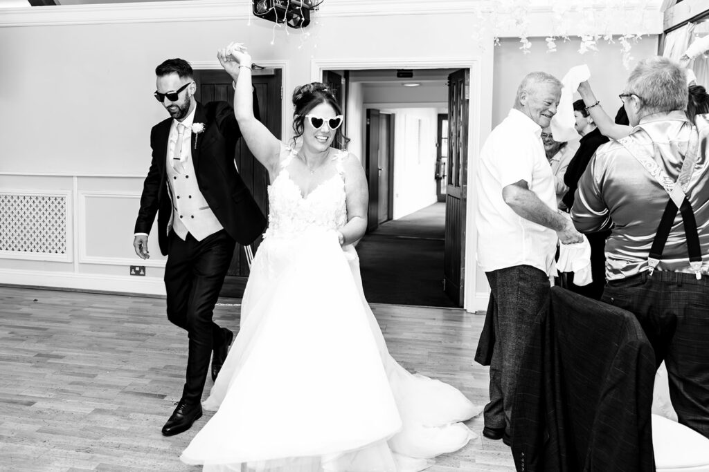 Bride throwing the bouquet, black and white at Newtown House Hotel, Hayling Island