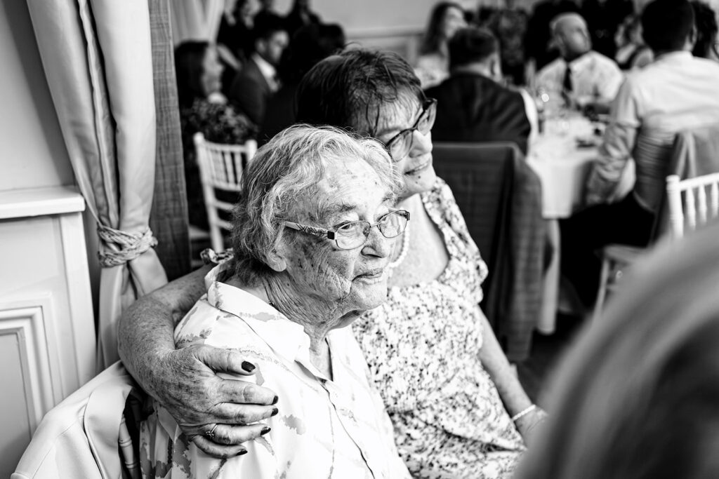 Guests laughing during the speeches, black and white at Newtown House Hotel, Hayling Island