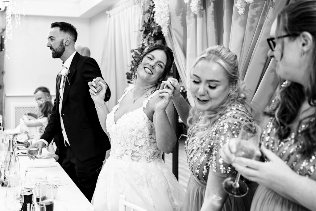Bride greeting guests, black and white at Newtown House Hotel, Hayling Island
